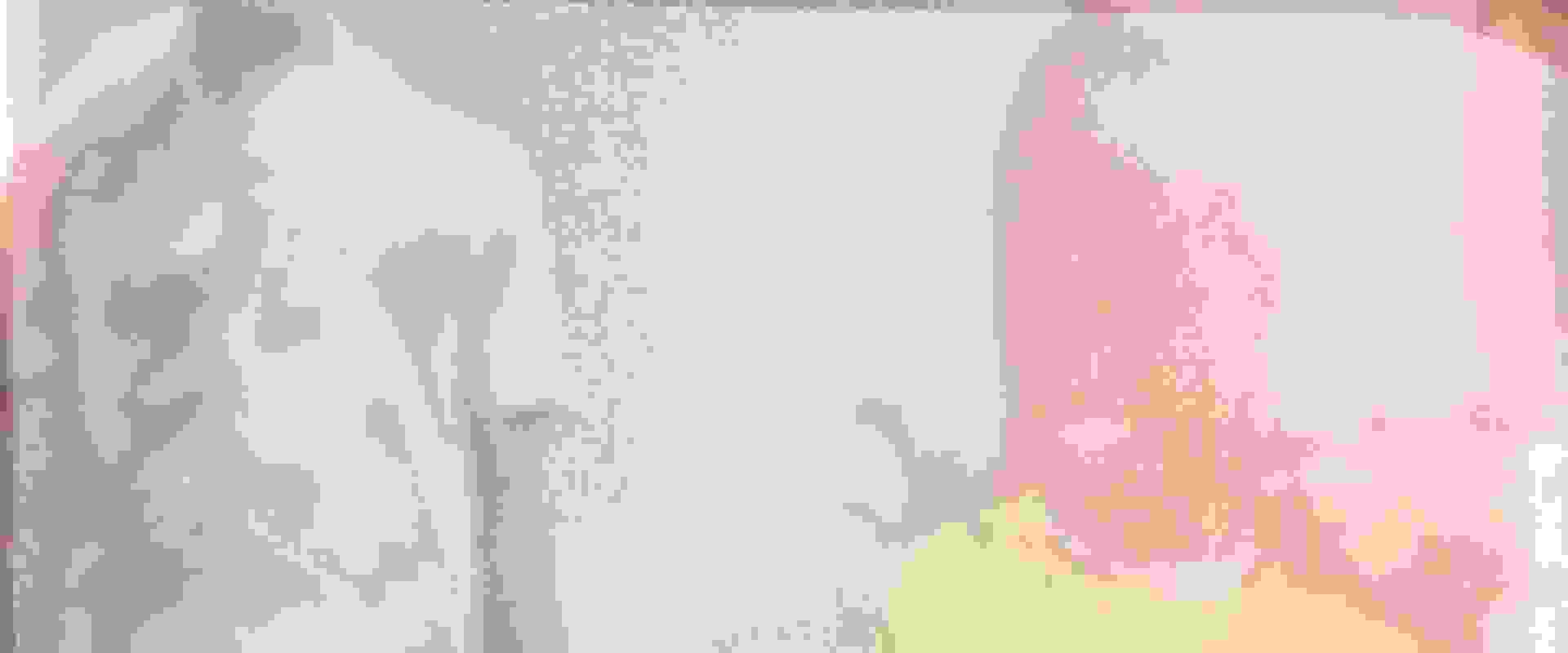 The image shows a close-up view of a person's arm, with a pink and white striped shirt visible in the background.