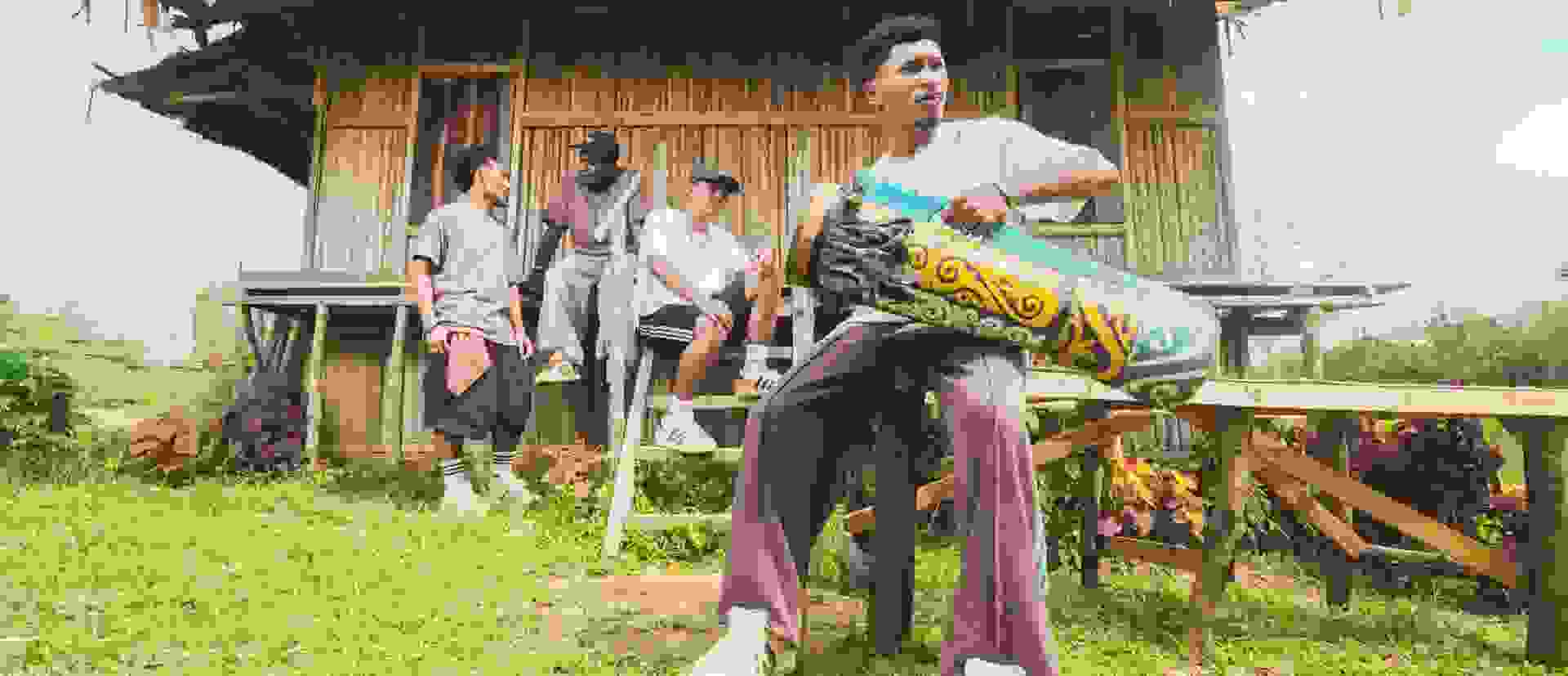 The image shows a cluttered room with various objects and toys scattered throughout, including plush animals, a wooden chair, and other miscellaneous items.