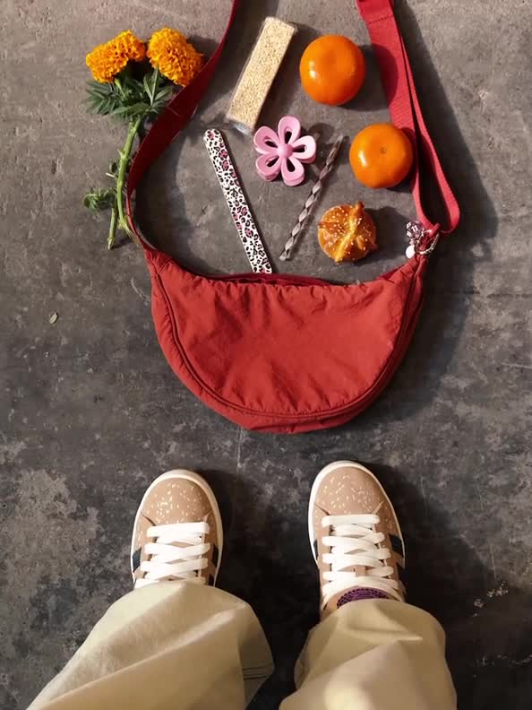 The image shows a variety of items, including a towel with a striped pattern, a pair of shoes, and various snacks and accessories on a concrete surface.