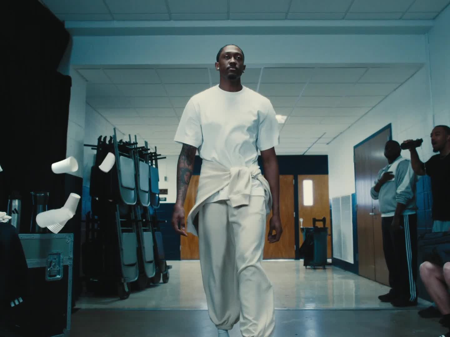 A blurred, close-up view of a notebook or document with a metal binder or clip visible in the foreground, set against a hazy, out-of-focus background.