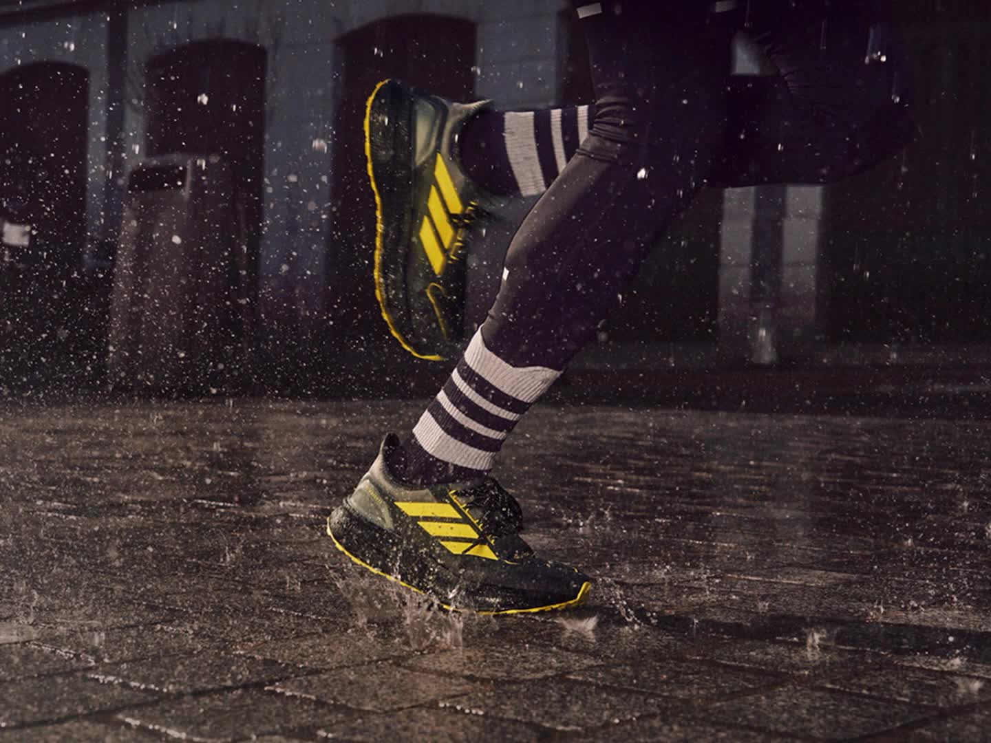 3D close-up image montage of legs running through a puddle wearing Ultraboost 5 GTX and adidas apparel.