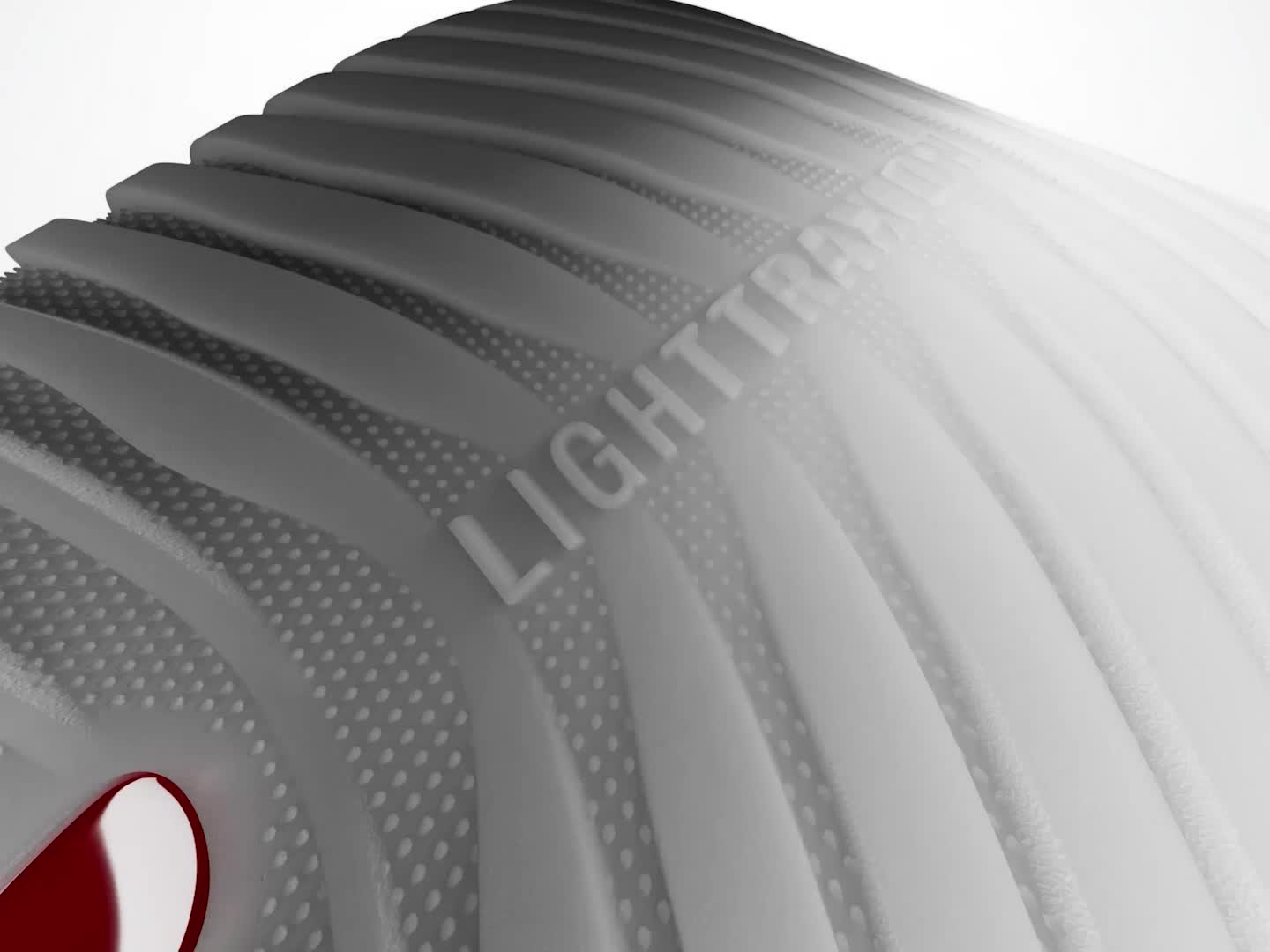 A silver and red rocket-shaped object with text on its surface stands against a plain background.