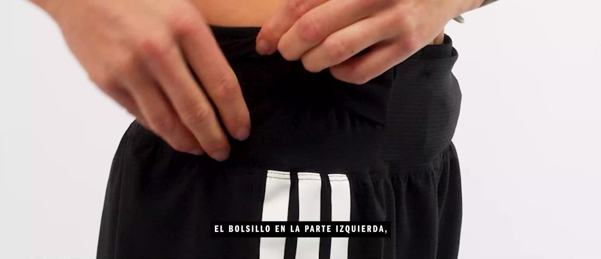 The image shows a pair of white and black athletic shorts with the text "ADIZERO GEL POCKET SHORT" printed on them.