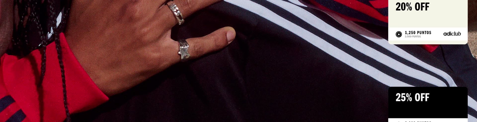 A close-up view of a person's hand grasping the sleeve of a dark-colored garment, with a blurred background.