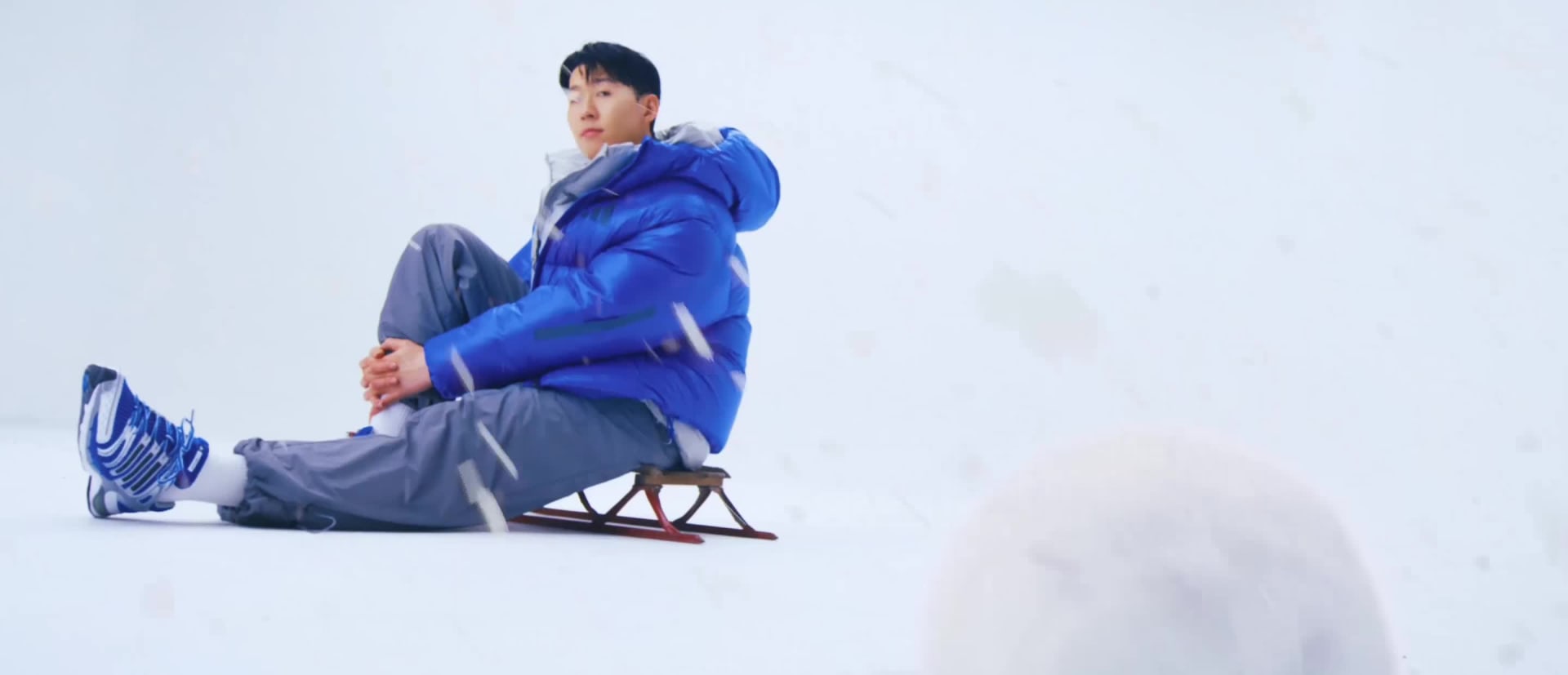 A young woman with long dark hair and a warm smile, set against a blurred background.