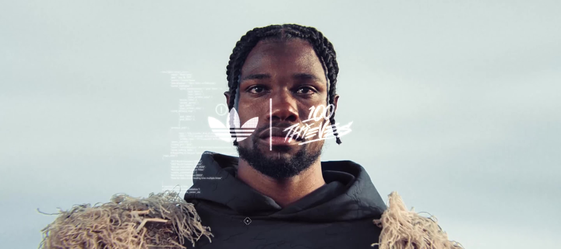A video opens on Noah Lyles’ face, then zooms out to show him dressed in the adidas Originals x 100 Thieves collection.