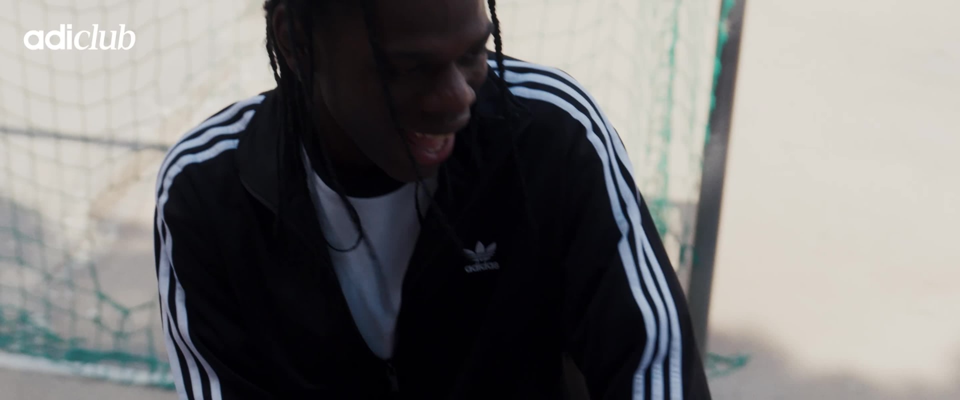 A group of friends wearing adidas Originals apparel walking down some steps. 