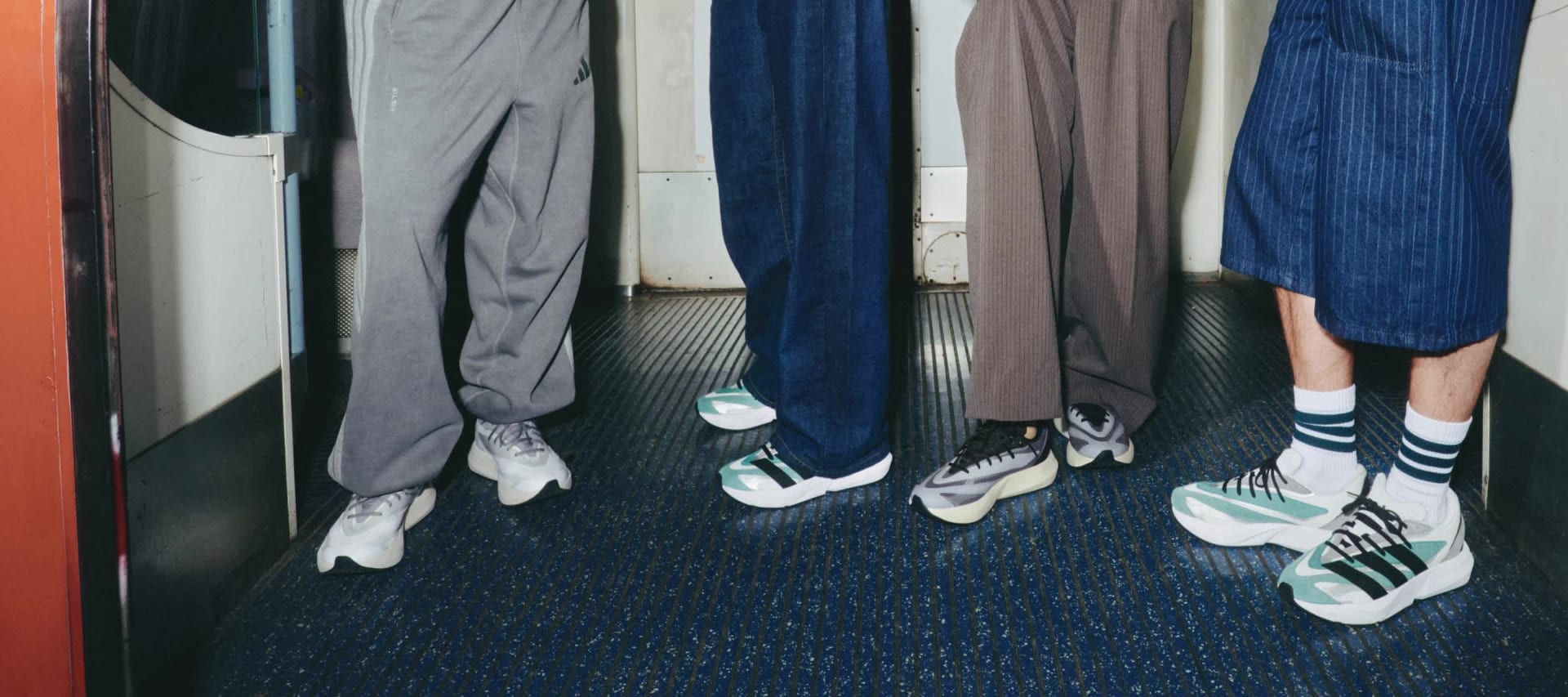 Close-up of blue and grey adidas Lightblaze shoes on foot, worn on a bus.
