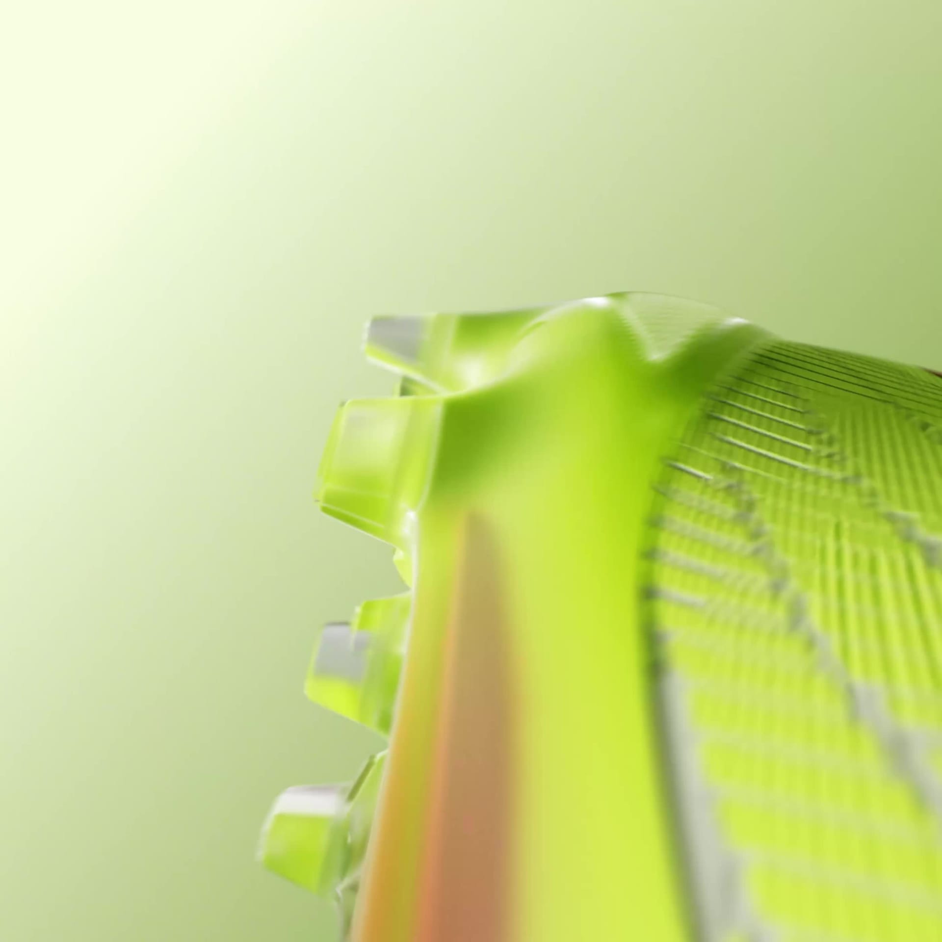 A white and neon green soccer cleat with laces on a blurred green background.