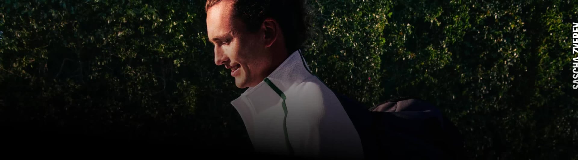 The image depicts a close-up of two individuals in an intimate embrace, surrounded by a lush, floral background.