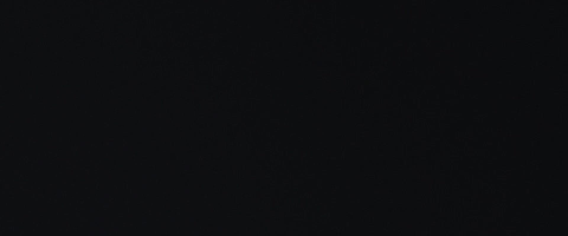 A close-up view of a person's face, with a pensive expression and a blurred background.