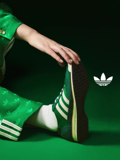 A slideshow of the blue and green version of the adidas SL 72, pictured on-foot and paired with a white adidas sock. 